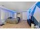 Comfortable bedroom featuring wood floors, a bed, TV and closet space at 8435 Hilltop Ln, Martinsville, IN 46151