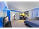 Unique bedroom with vibrant blue accents, TV, study area and view to the second floor at 8435 Hilltop Ln, Martinsville, IN 46151