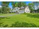 A beautiful home with lush green lawn, mature trees and a long driveway leading to the attached garage at 8435 Hilltop Ln, Martinsville, IN 46151