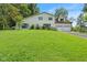 Charming home with a well-manicured lawn, an attached two-car garage, and a beautiful yard with mature trees at 8435 Hilltop Ln, Martinsville, IN 46151