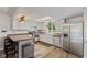Bright kitchen with stainless steel appliances, including a large refrigerator, light countertops and updated cabinets at 8435 Hilltop Ln, Martinsville, IN 46151