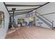 Spacious living room with wood floors, exposed ceiling beams, a wood-burning fireplace and a staircase to an upper level at 8435 Hilltop Ln, Martinsville, IN 46151