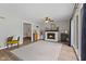 Bright and inviting room with a white brick fireplace, a neutral rug, and large window with view of the property at 8435 Hilltop Ln, Martinsville, IN 46151