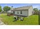 Well-maintained backyard with mature trees, green grass, and outdoor sitting areas, great for entertaining at 8526 Country Meadows Dr, Indianapolis, IN 46234