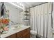 Functional bathroom includes a vanity, toilet, and shower with stylish curtain at 8526 Country Meadows Dr, Indianapolis, IN 46234