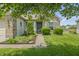 Charming home with a green front door, lush landscaping, brick accents, and a well-manicured lawn at 8526 Country Meadows Dr, Indianapolis, IN 46234