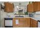 Kitchen with wooden cabinetry, stainless steel appliances, black sink and white countertops at 8526 Country Meadows Dr, Indianapolis, IN 46234