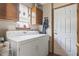 Functional laundry room equipped with washer, dryer, cabinet storage, and exterior access at 8526 Country Meadows Dr, Indianapolis, IN 46234