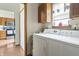 Practical laundry room with standard washer and dryer, natural light and access to the kitchen at 8526 Country Meadows Dr, Indianapolis, IN 46234