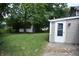 Large backyard shows the side of the house and access to a shed at 9016 Neptune Dr, Indianapolis, IN 46229
