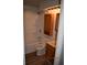 Cozy bathroom with a shower and tub, and a storage cabinet above the toilet at 9016 Neptune Dr, Indianapolis, IN 46229