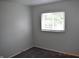 Neutrally decorated bedroom with plush carpeting and a window that provides natural light at 9016 Neptune Dr, Indianapolis, IN 46229