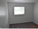 Bright bedroom featuring plush carpeting, neutral walls, and a sun-filled window at 9016 Neptune Dr, Indianapolis, IN 46229