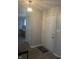 Clean entryway with a white front door, light grey walls, and wood-look flooring at 9016 Neptune Dr, Indianapolis, IN 46229