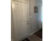 Interior view of a white front door with a decorative 'Walk by Faith' sign and light switch at 9016 Neptune Dr, Indianapolis, IN 46229