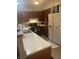 This kitchen features wood cabinets, white countertops, modern appliances, and laminate flooring at 9016 Neptune Dr, Indianapolis, IN 46229