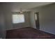 Neutral living room with plush brown carpet, a ceiling fan, and a bright window at 9016 Neptune Dr, Indianapolis, IN 46229