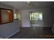 Open living room features a decorative mirror and access to a bright sun room at 9016 Neptune Dr, Indianapolis, IN 46229