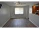 Living room featuring laminate flooring, neutral walls, and a window offering bright light at 9016 Neptune Dr, Indianapolis, IN 46229
