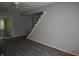 Bright living room with stairs and modern laminate flooring leading to the next level at 9016 Neptune Dr, Indianapolis, IN 46229
