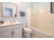 Bright bathroom featuring a vanity with a sink, toilet, and a shower-tub combination at 9248 Hawley Dr, Indianapolis, IN 46216
