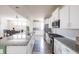 Modern kitchen with white cabinets, stainless steel appliances, and open view to the dining area at 9248 Hawley Dr, Indianapolis, IN 46216