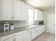Bright kitchen boasts white cabinets, granite countertops, and plenty of storage space at 9248 Hawley Dr, Indianapolis, IN 46216