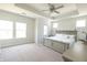 Spacious main bedroom with plush carpet, tray ceiling, fan, and large windows offering ample light at 9248 Hawley Dr, Indianapolis, IN 46216
