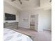 Relaxing main bedroom with tray ceiling, TV, view to bathroom, and a patterned bedspread at 9248 Hawley Dr, Indianapolis, IN 46216