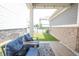 Relaxing outdoor patio featuring comfortable seating, stylish rug, and overhead string lights at 9248 Hawley Dr, Indianapolis, IN 46216