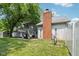 Expansive backyard featuring a patio with pergola, a brick chimney, and a well-maintained lawn for outdoor enjoyment at 9256 Colgate St, Indianapolis, IN 46268
