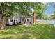 Lush backyard with a patio, pergola, hammocks, privacy fence and mature trees, offering a relaxing outdoor space at 9256 Colgate St, Indianapolis, IN 46268