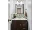 Charming powder room featuring modern vanity with mosaic tile, framed mirror, and stylish lighting at 9256 Colgate St, Indianapolis, IN 46268