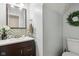Charming powder room featuring modern vanity with mosaic tile, framed mirror, and stylish lighting at 9256 Colgate St, Indianapolis, IN 46268