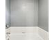 This is a close-up of a white bathtub with a chrome faucet, gray wall, and white tile surround at 9256 Colgate St, Indianapolis, IN 46268