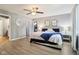 Spacious main bedroom with stylish furniture, ceiling fan, wood-look floors, and ample closet space at 9256 Colgate St, Indianapolis, IN 46268