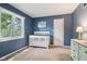 A bedroom features natural light from a window, a crib, and neutral-toned walls at 9256 Colgate St, Indianapolis, IN 46268