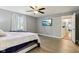 Bright bedroom with wood-look floors, ceiling fan, large windows, and en-suite access at 9256 Colgate St, Indianapolis, IN 46268