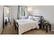 Bedroom with a full-length mirror, large window, and bed, offering a bright and airy feel at 9256 Colgate St, Indianapolis, IN 46268