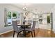 Bright dining area open to the kitchen, featuring a round table and lovely backyard view at 9256 Colgate St, Indianapolis, IN 46268