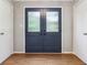 View of a double door entryway with sidelights, a wood floor and white trim at 9256 Colgate St, Indianapolis, IN 46268