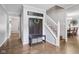 Spacious foyer with hardwood floors, staircase, coat rack and wreath at 9256 Colgate St, Indianapolis, IN 46268