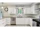 Bright kitchen featuring white cabinets, stainless steel appliances, subway tile backsplash, and modern fixtures at 9256 Colgate St, Indianapolis, IN 46268