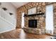 Living room features a stone fireplace, hardwood floors and staircase at 9256 Colgate St, Indianapolis, IN 46268