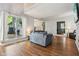 Bright living room boasts hardwood floors and large windows overlooking a lush backyard at 9256 Colgate St, Indianapolis, IN 46268