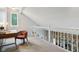 Loft space featuring a work area with desk, chair, and decorative railing at 9256 Colgate St, Indianapolis, IN 46268