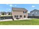 Lovely backyard includes a concrete patio, dark wood fence, and well-manicured lawn at 937 Maple Stone Dr, Greenwood, IN 46143
