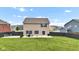 Exterior view of home showcasing fenced backyard with patio, outdoor furniture, and a well-maintained lawn at 937 Maple Stone Dr, Greenwood, IN 46143