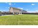 Lovely backyard showcasing a lush green lawn, a patio area, and a well-maintained dark wood fence at 937 Maple Stone Dr, Greenwood, IN 46143