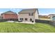 Spacious backyard featuring a well-maintained lawn, patio area with outdoor furniture, and privacy fence at 937 Maple Stone Dr, Greenwood, IN 46143